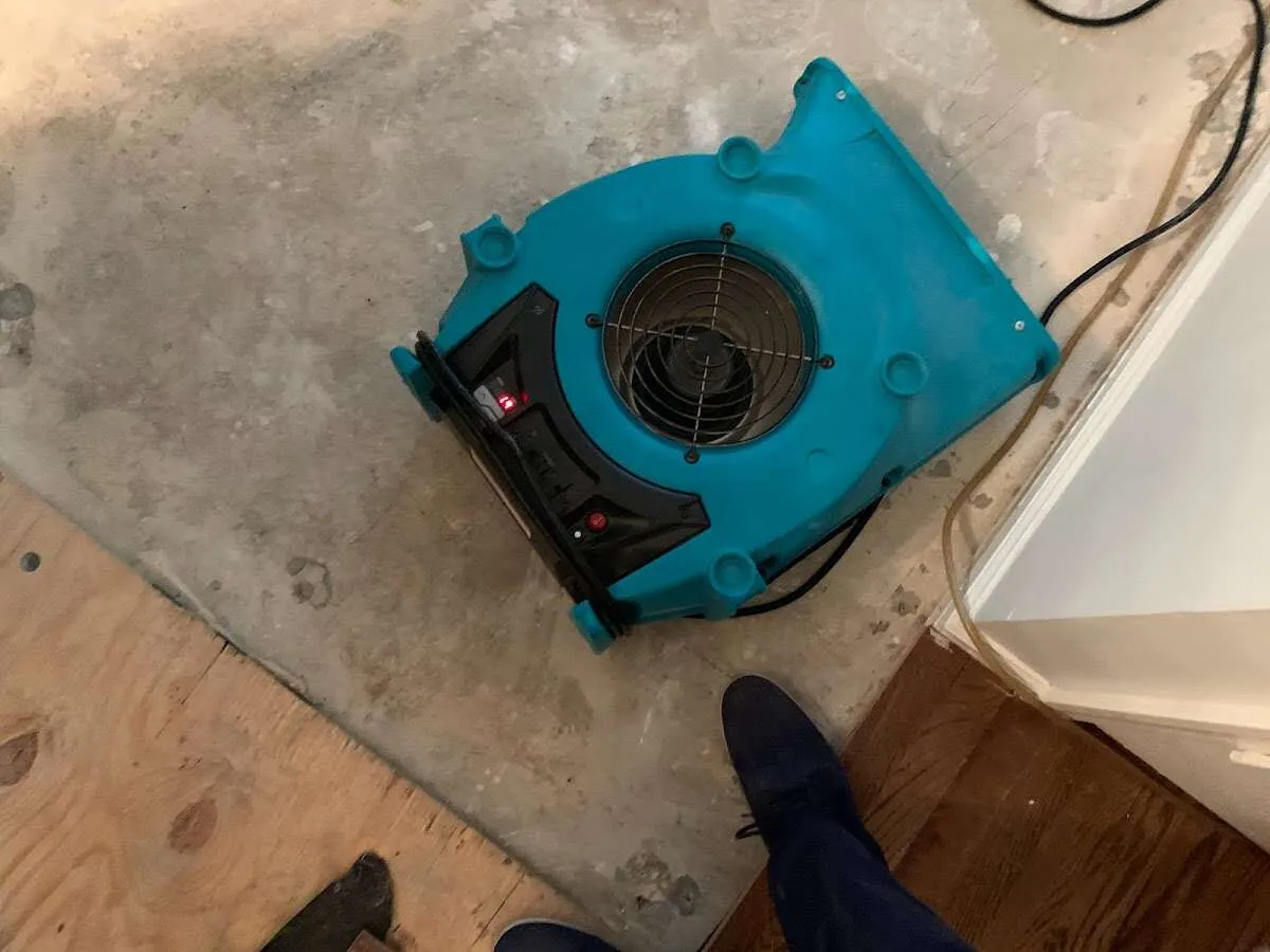 Air mover drying subfloor during Leak Detection & Repair in Brown Deer
